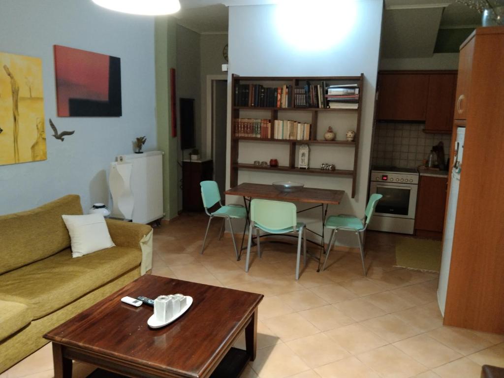 a living room with a couch and a table at ησυχες διακοπες in Kalamata