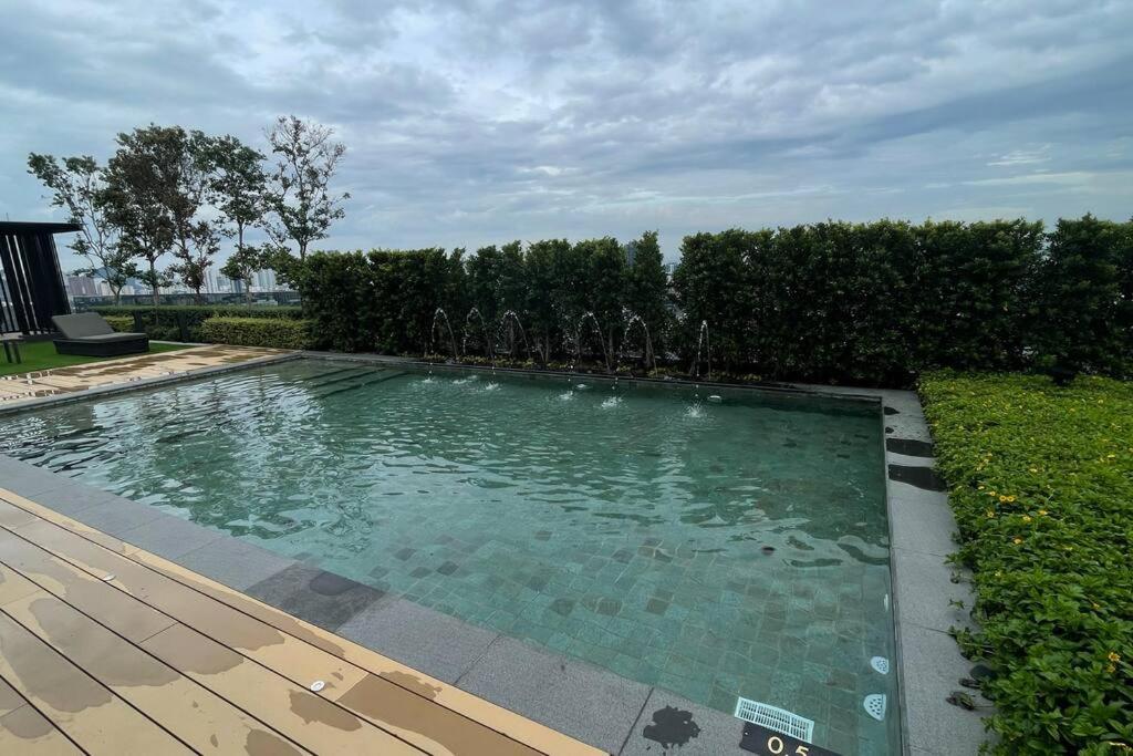 a swimming pool in a yard with a wooden deck at Beacon Executive Suites #Georgetown #InfinityPool #15 in George Town