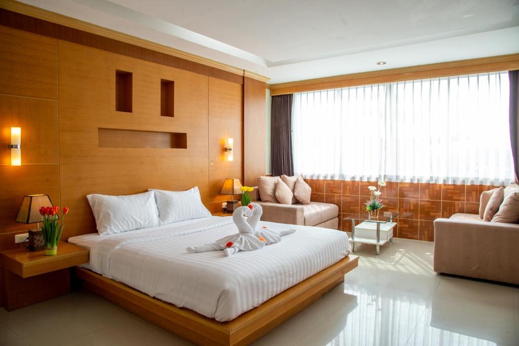 Un dormitorio con una cama con un pato blanco. en Patong eyes, en Patong Beach