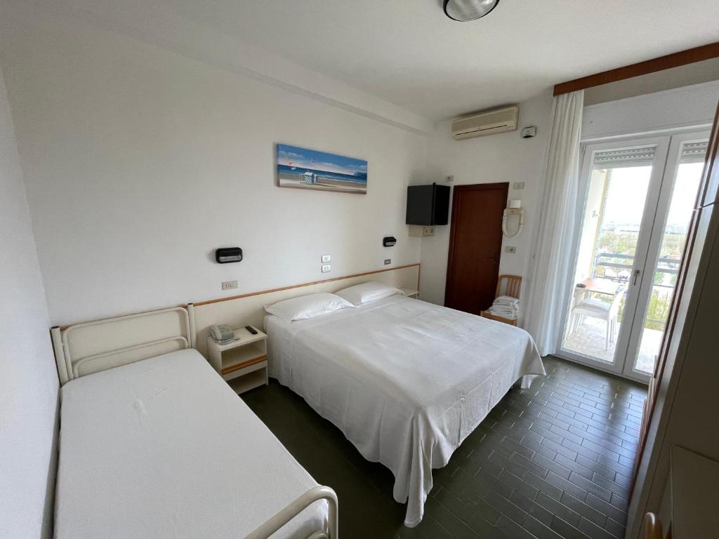 Postel nebo postele na pokoji v ubytování Hotel Pari
