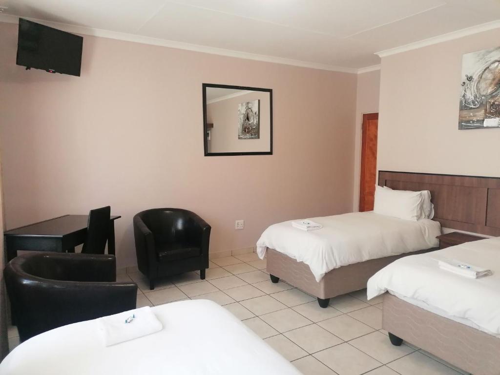 Postel nebo postele na pokoji v ubytování Andante Guesthouse Klerksdorp