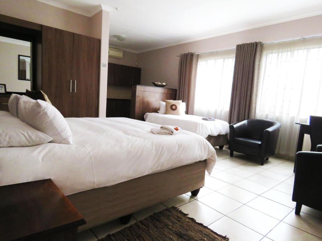 Postel nebo postele na pokoji v ubytování Andante Guesthouse Klerksdorp