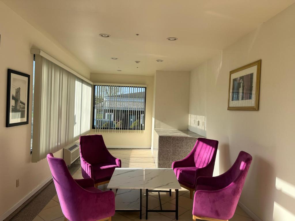 a dining room with purple chairs and a table at The Hamlet Inn at Warwick in Warwick