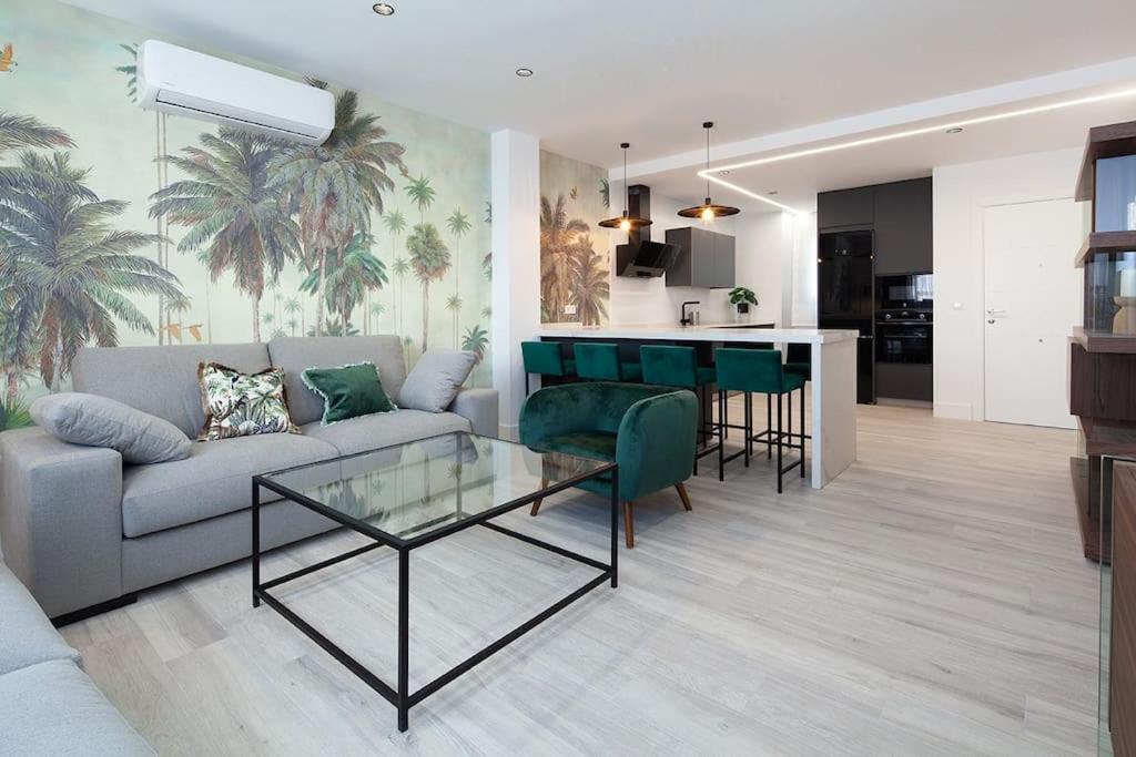 a living room with a couch and a table at Stunning apartment in Nervion with parking in Seville