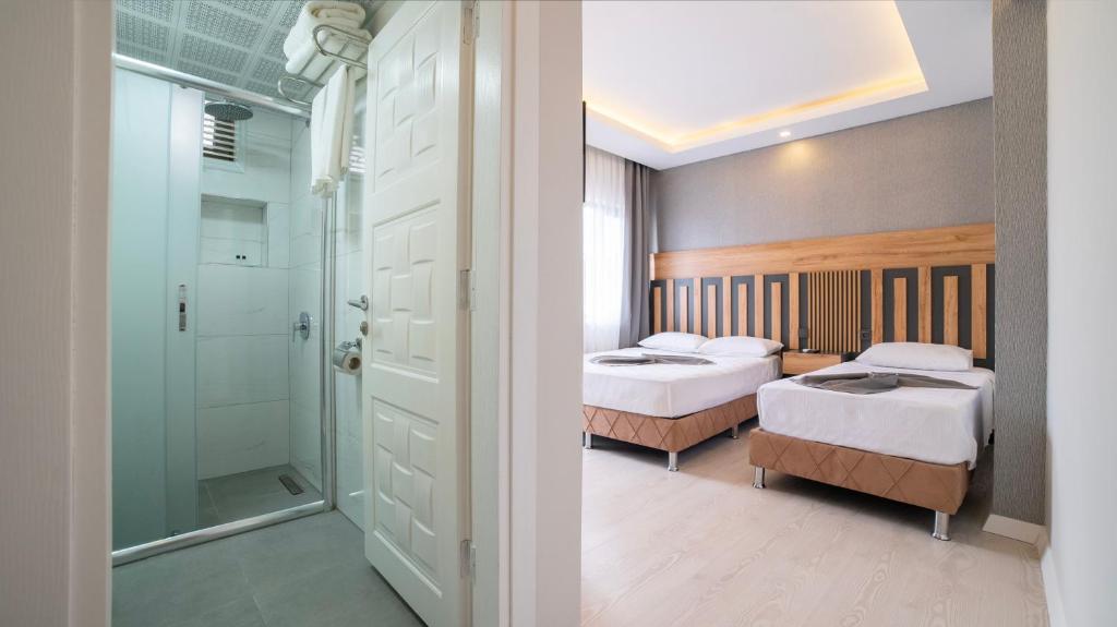 Postel nebo postele na pokoji v ubytování Kafkas Hotel