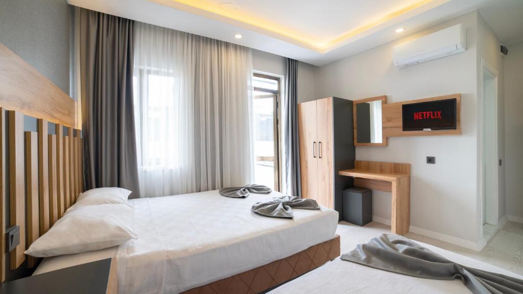 Postel nebo postele na pokoji v ubytování Kafkas Hotel