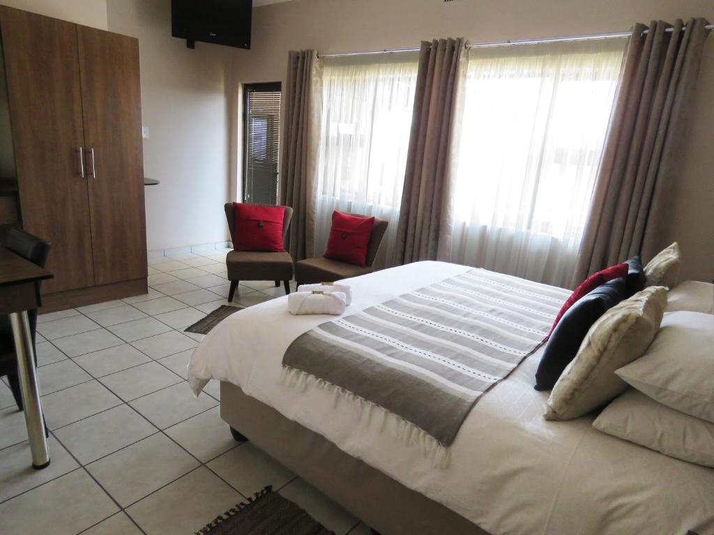 Postel nebo postele na pokoji v ubytování Andante Guesthouse Klerksdorp