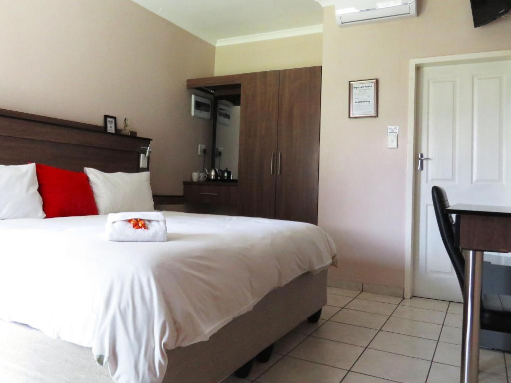Postel nebo postele na pokoji v ubytování Andante Guesthouse Klerksdorp