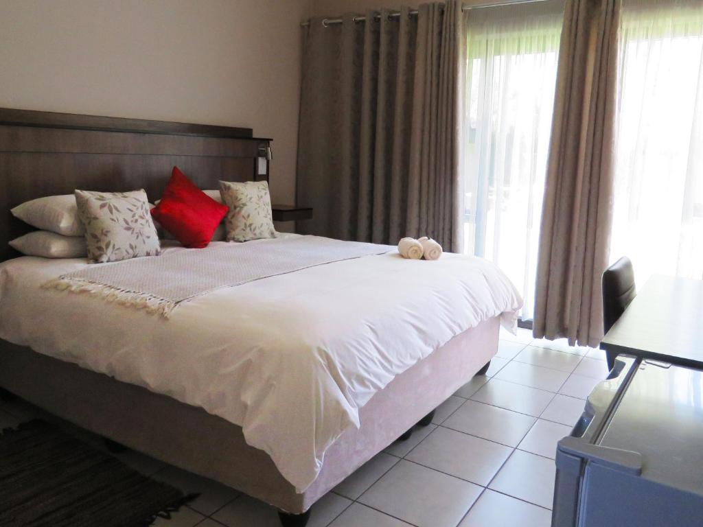 Postel nebo postele na pokoji v ubytování Andante Guesthouse Klerksdorp