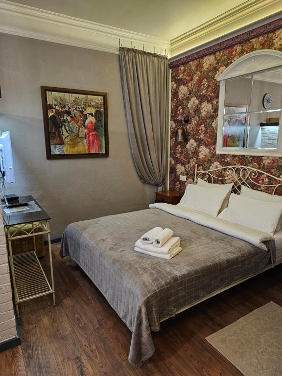 a bedroom with a bed with a towel on it at Studios on Grigore Vieru in Chişinău