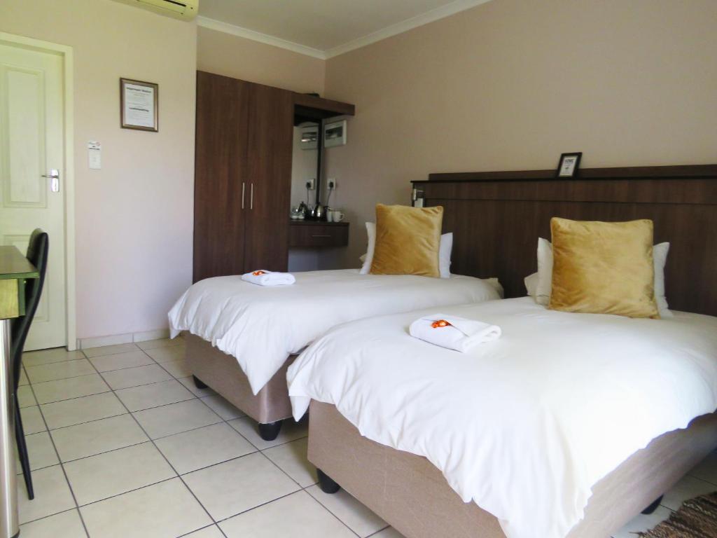 Postel nebo postele na pokoji v ubytování Andante Guesthouse Klerksdorp