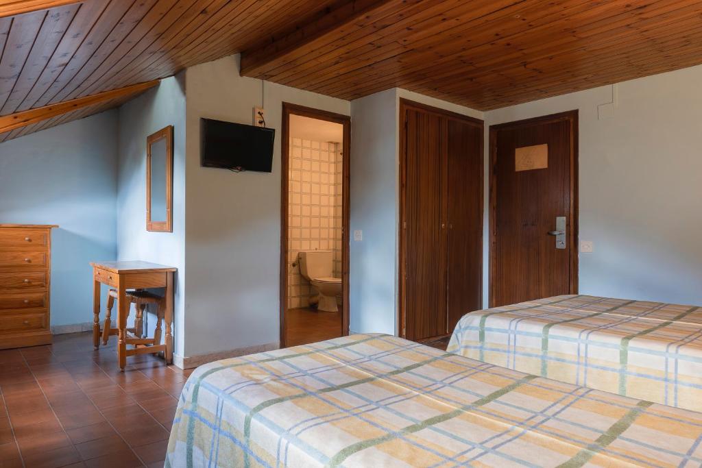 Postel nebo postele na pokoji v ubytování Hotel Cardós