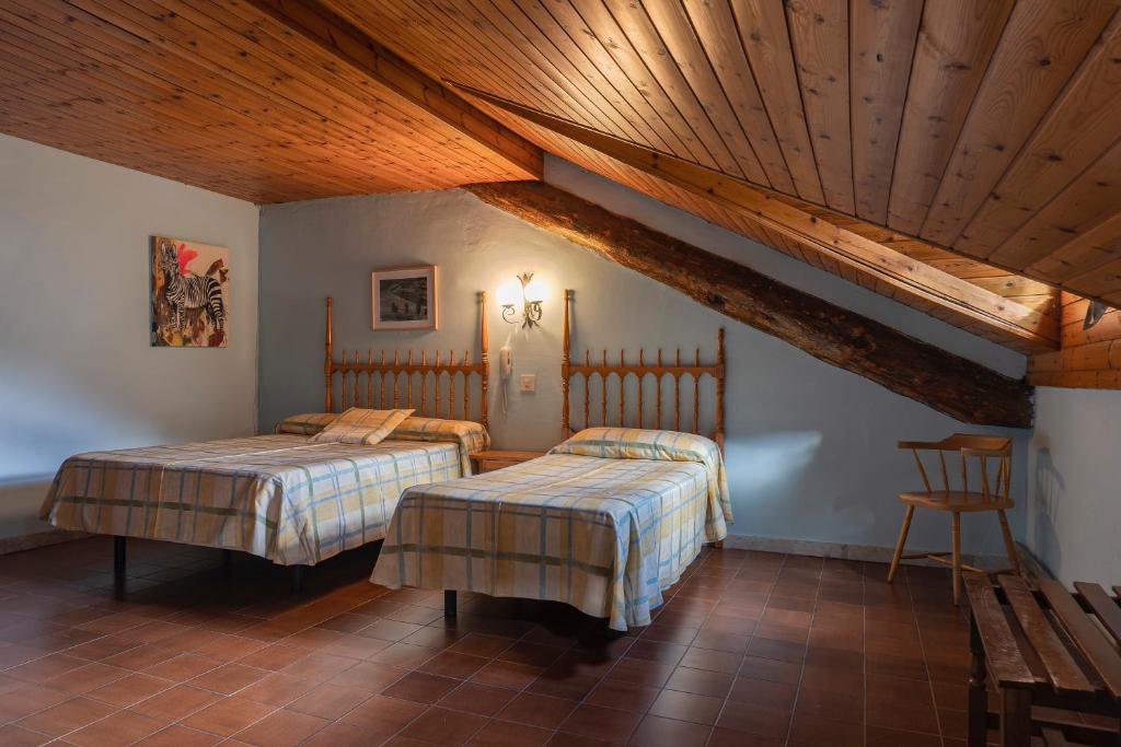 Postel nebo postele na pokoji v ubytování Hotel Cardós