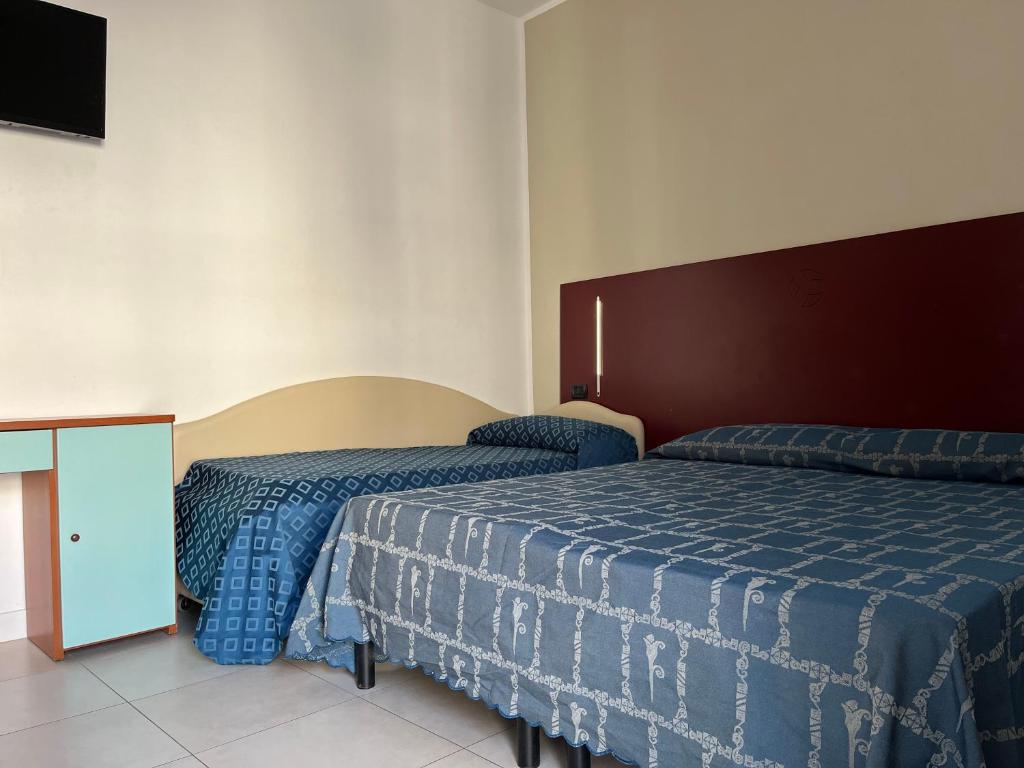Postel nebo postele na pokoji v ubytování Fellini Rimini