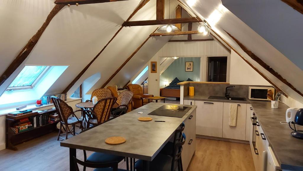 uma cozinha e sala de jantar num sótão em appartement au calme em Pordic