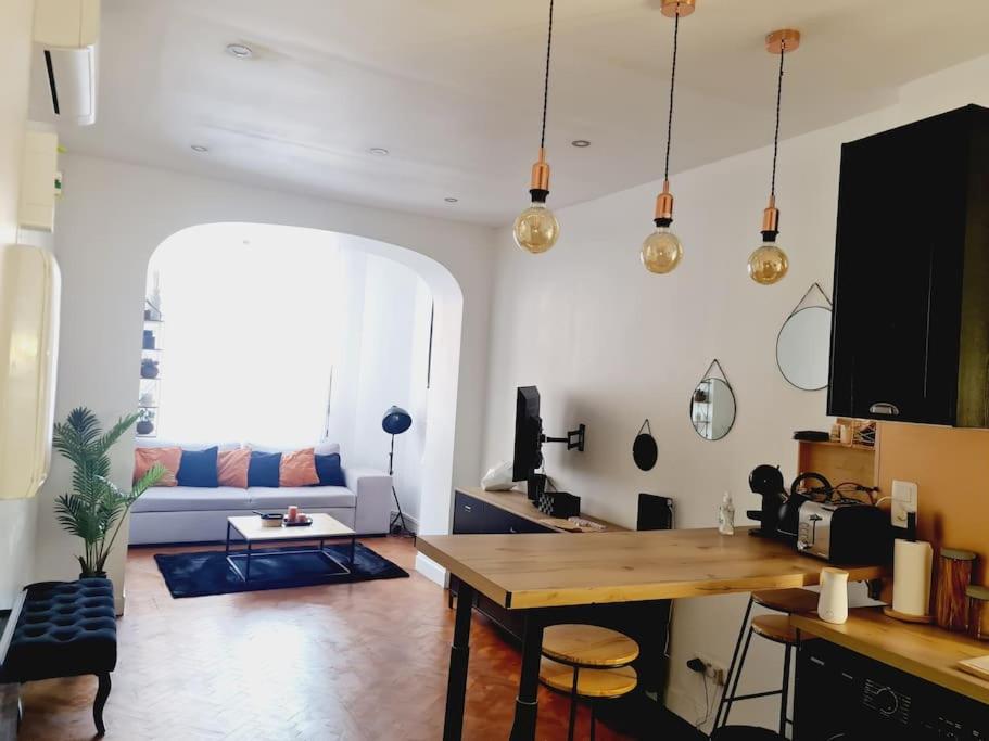 un salon avec une table et un canapé dans l'établissement Appartement tout confort, agréable à vivre, à Nice
