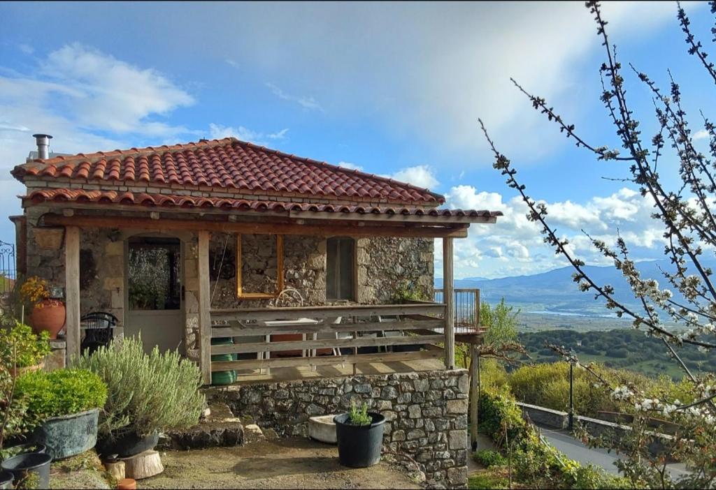 a small house with a stone wall at The Artist's House in Psárion