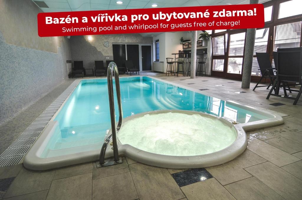 a bath tub in the middle of a pool at Penzion Pod Radnicí in Hustopeče