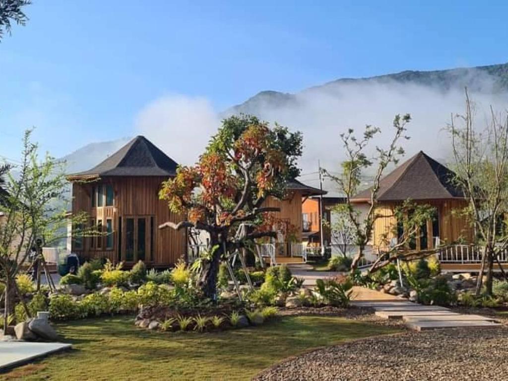 a house with a tree in the middle of a yard at Times Klang Sapan Resort 