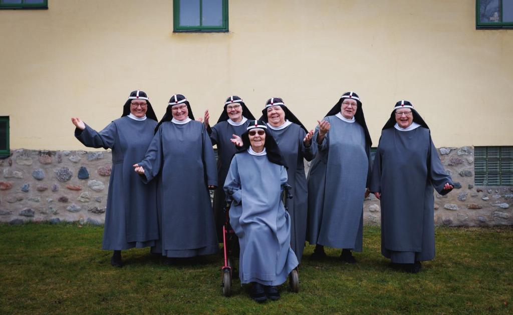 a group of women in robes posing for a picture at Birgittasystrarnas Gästhem in Vadstena