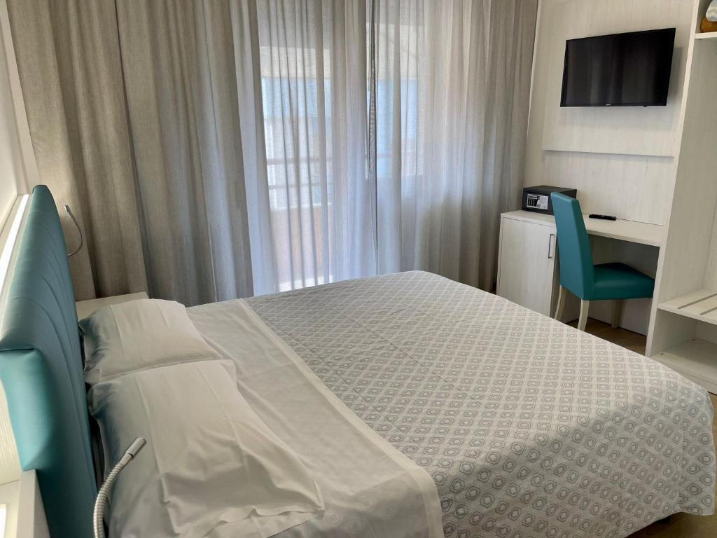 Postel nebo postele na pokoji v ubytování Hotel Corallo