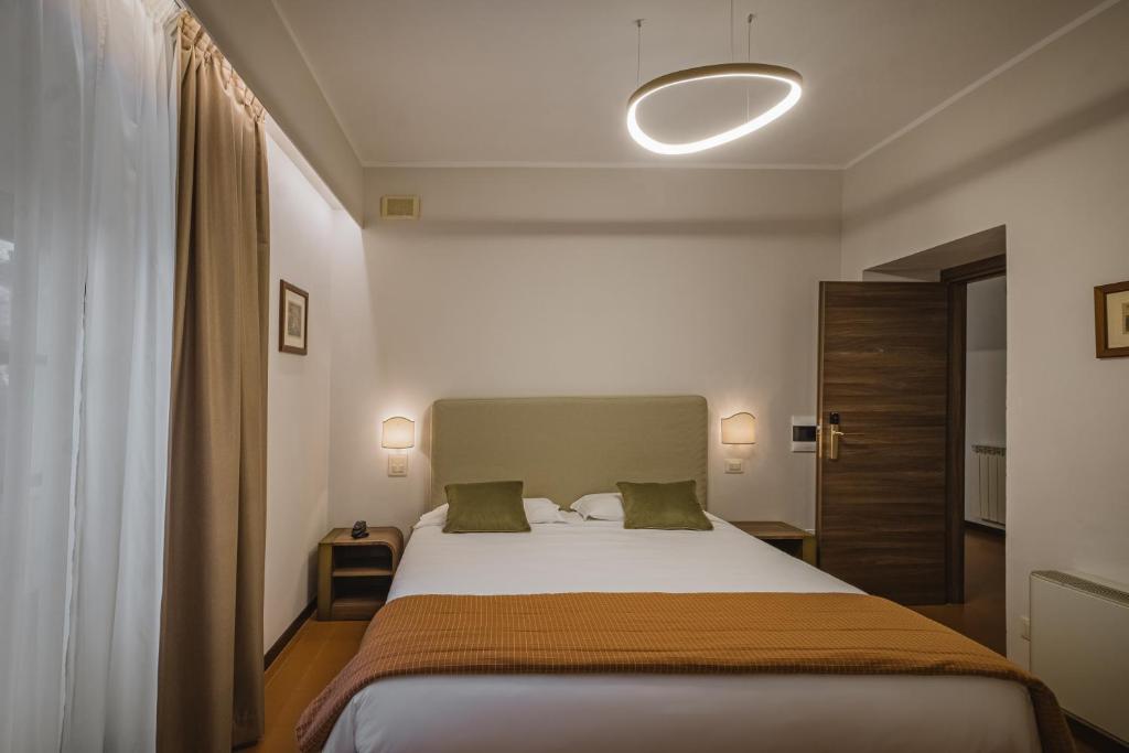 Postel nebo postele na pokoji v ubytování Hotel Villa Montegranelli