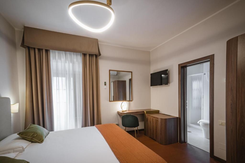 Postel nebo postele na pokoji v ubytování Hotel Villa Montegranelli