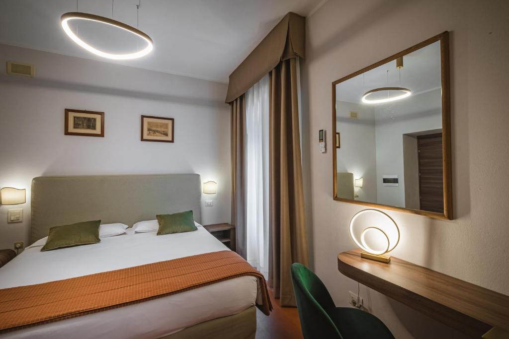 Postel nebo postele na pokoji v ubytování Hotel Villa Montegranelli