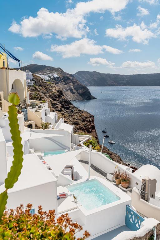 a view of the amalfi coast from a house with a swimming pool at Aristos Life Luxury Cave Villas in Oia