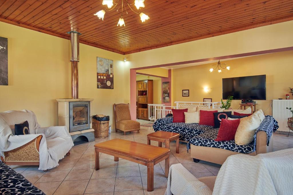 a large living room with couches and a fireplace at Villa Roxa Montuoso in Agios Leon