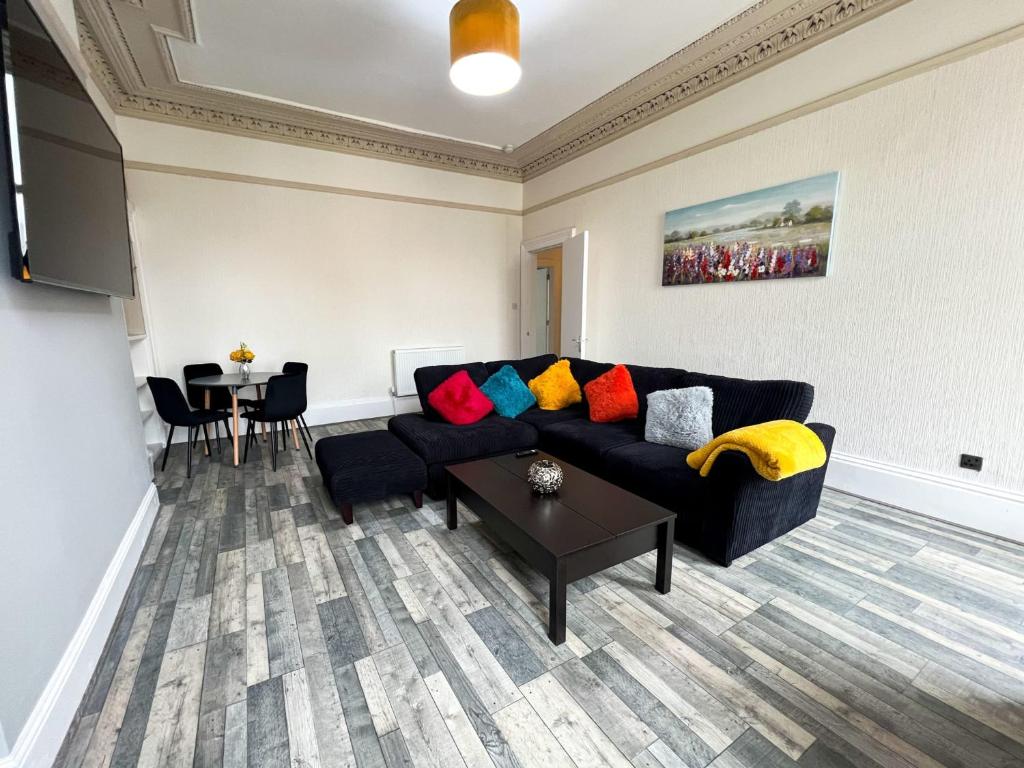 a living room with a couch and a table at Premium 2BR Flat in the City Centre in Glasgow