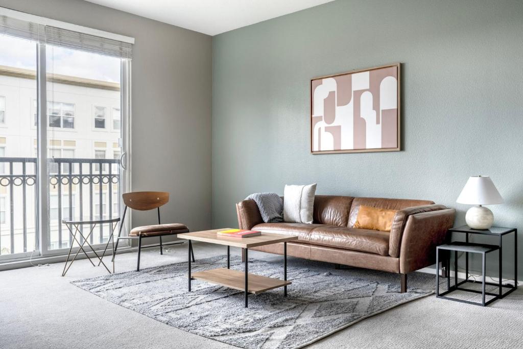 a living room with a couch and a table at Santana Row 2br townhouse w pool nr highways SFO-1327 in San Jose