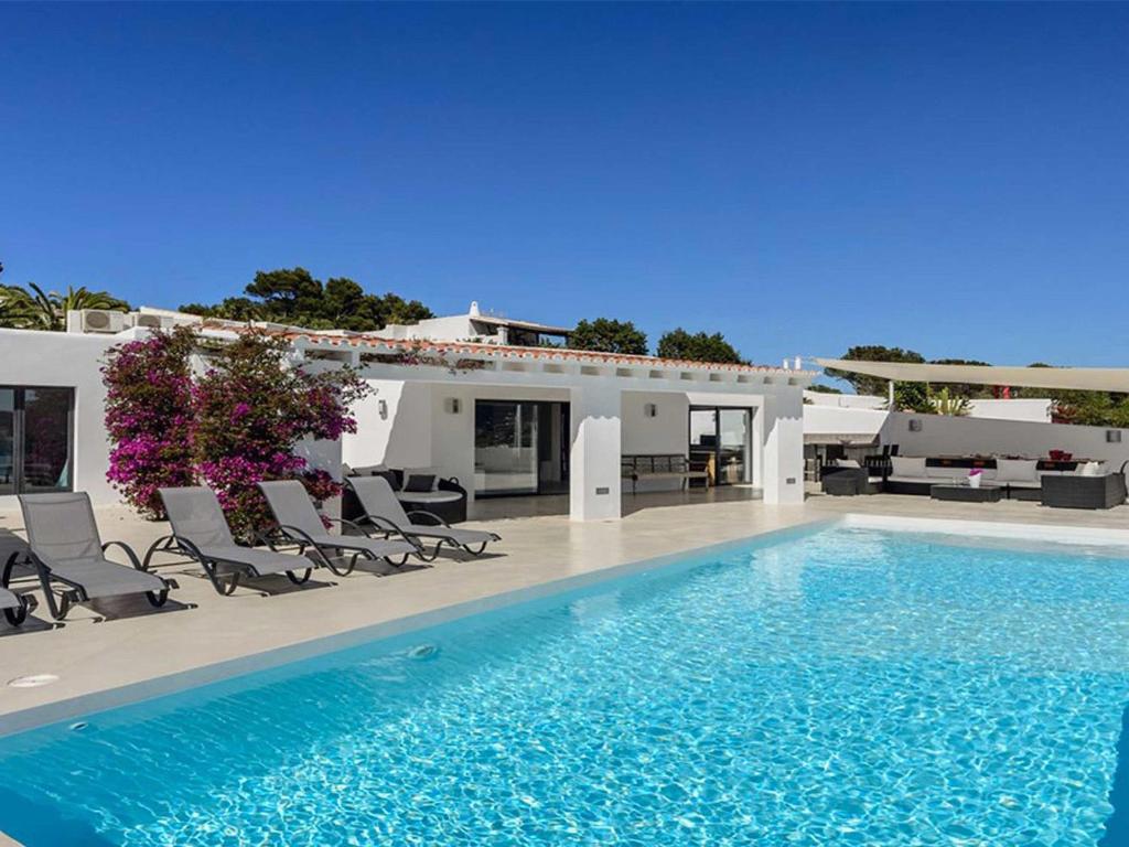 una piscina di fronte a una villa di Modern Villa with sea views a San Jose de sa Talaia