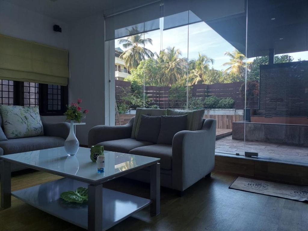a living room with a couch and a table at Terrace abode in Mangalore