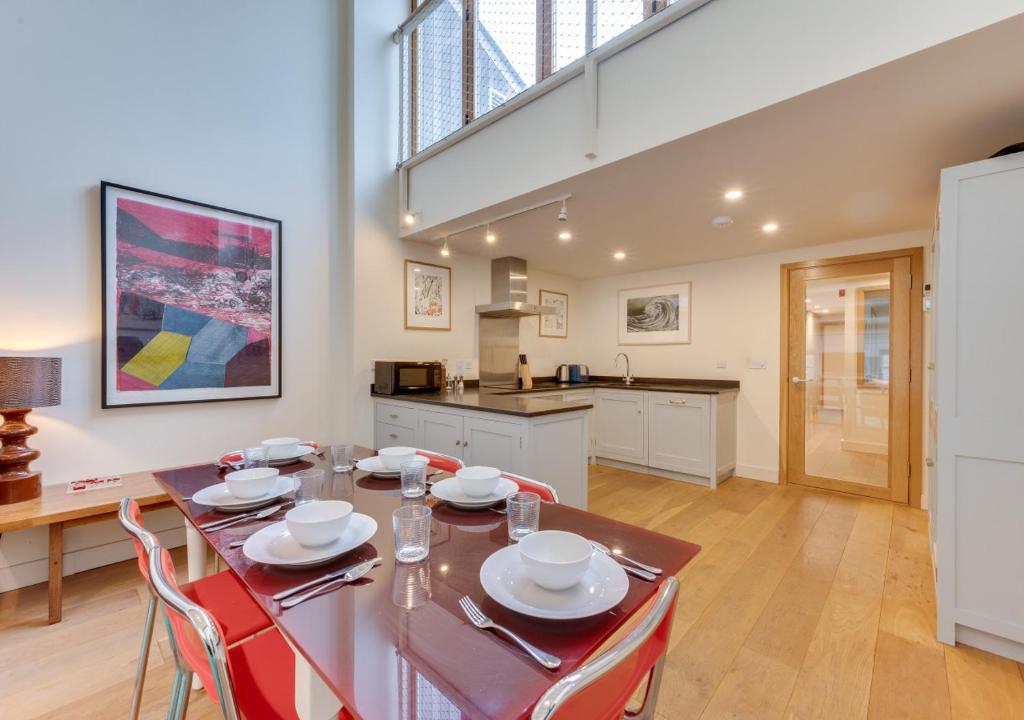 a kitchen and dining room with a table and chairs at 2 The Courtyard in Snape