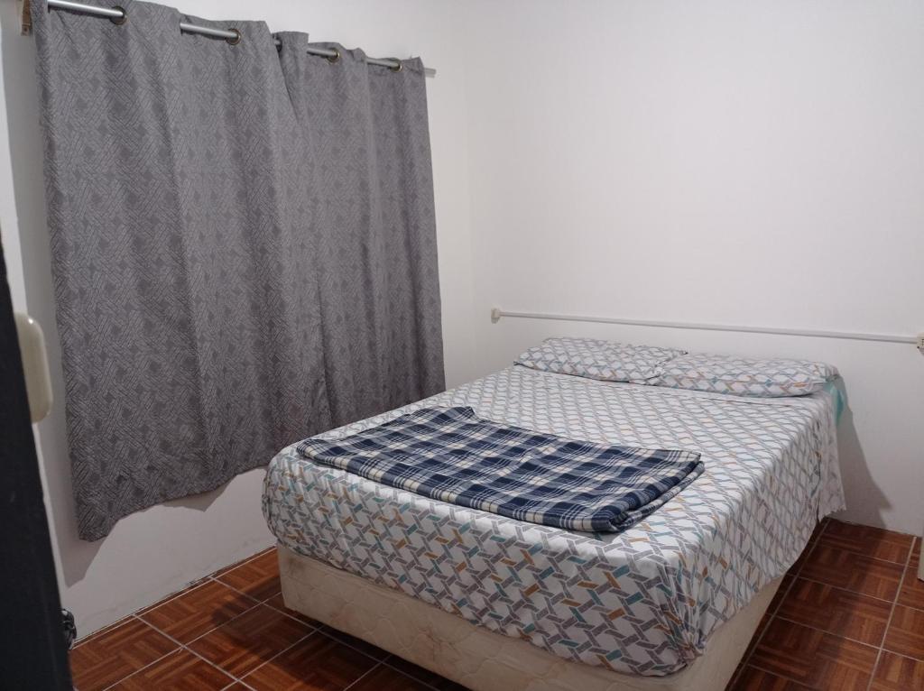 a small bedroom with a bed and a curtain at Tuc com in Durazno