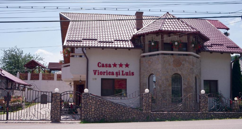 a building with a sign on the side of it at Casa Viorica și Luis in Câmpulung Moldovenesc