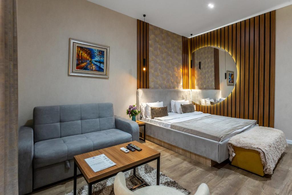 a hotel room with a bed and a couch at Seven Boutique Hotel Baku in Baku