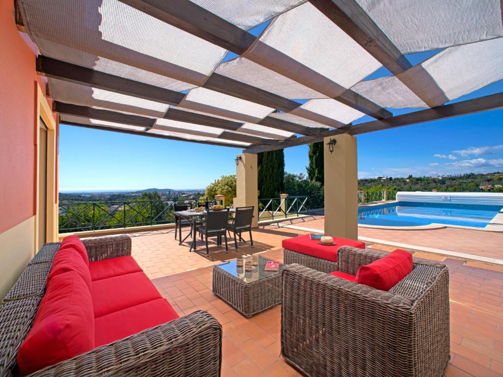 a patio with a couch and chairs and a pool at Holiday Home Montinho by Interhome in Loulé