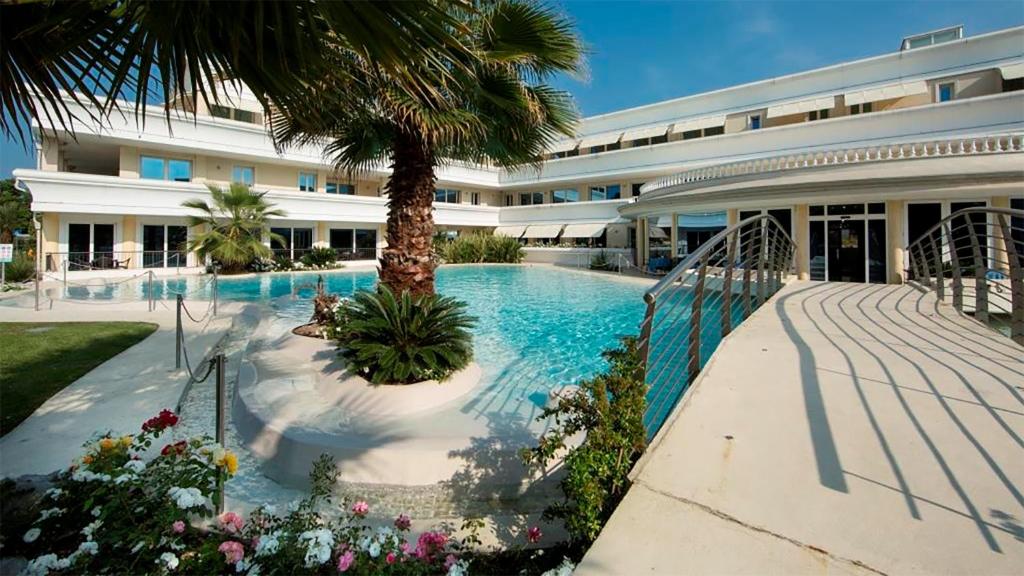 a swimming pool in front of a building at Relais du Lac Village - Italian Homing in Desenzano del Garda
