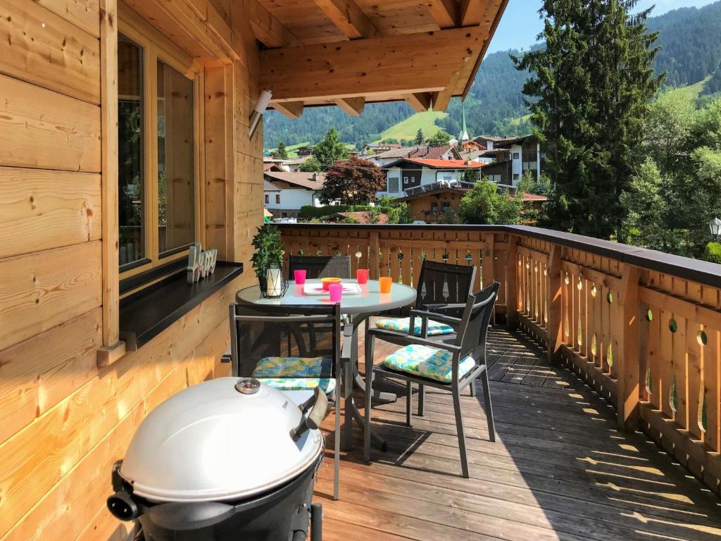 a patio with a table and a grill on a deck at Chalet Wildenbach by Interhome in Grafenweg