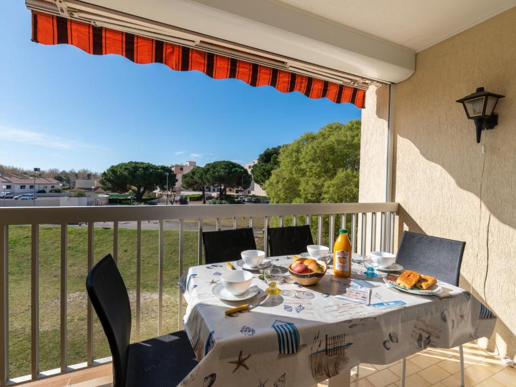 - une table sur un balcon avec une table et des chaises dans l'établissement Studio Los Amigos-9 by Interhome, au Grau-du-Roi