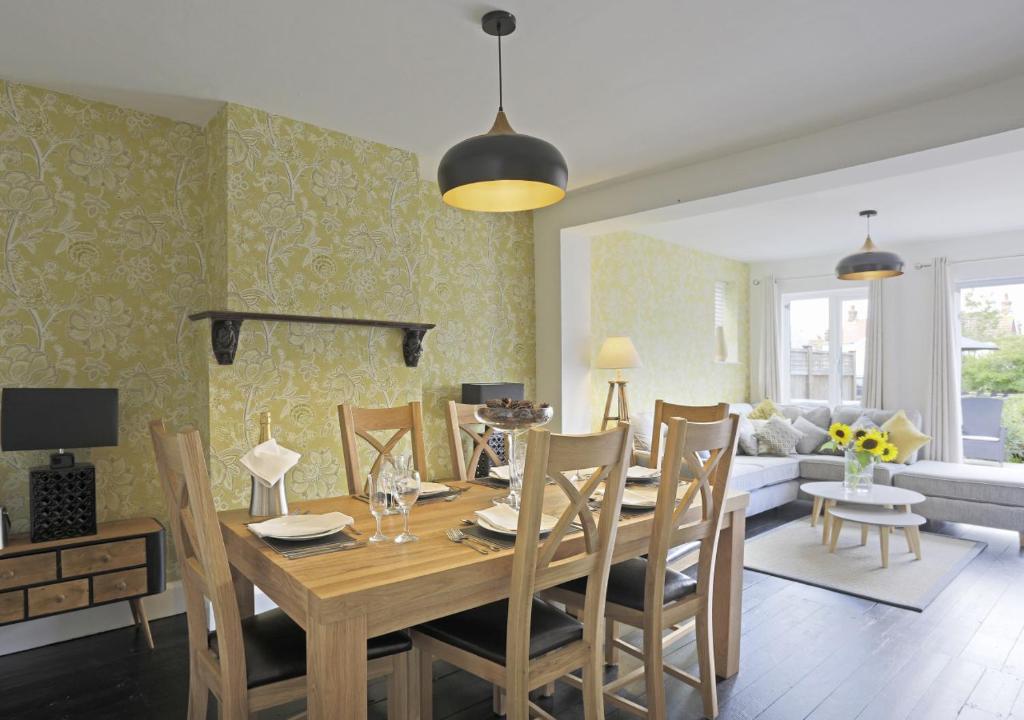 a dining room and living room with a table and chairs at Bon Amis in Southwold