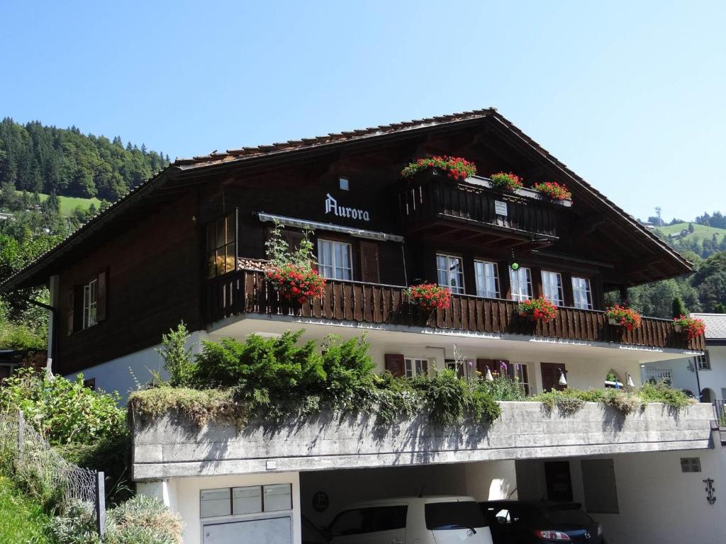 a building with flowers on the balconies of it at Apartment Aurora by Interhome in Engelberg