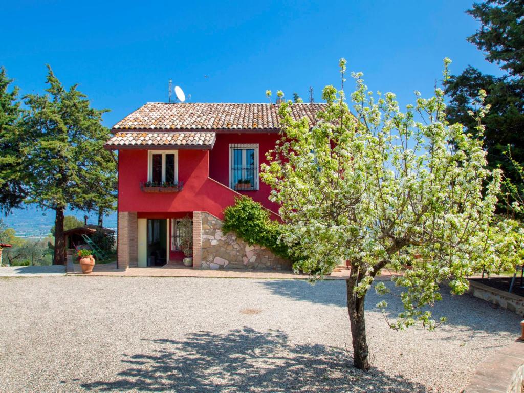a red house with a tree in front of it at Holiday Home La Letizia by Interhome in Collemancio