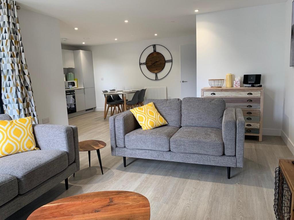 a living room with a couch and a table at 8 Middlecombe - Luxury Apartment at Byron Woolacombe, only 4 minute walk to Woolacombe Beach! in Woolacombe