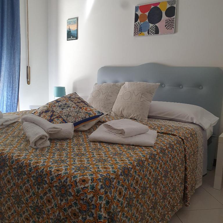 a bed with pillows on it in a bedroom at Alba central City in Palermo