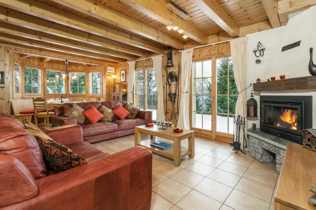 a living room with a couch and a fireplace at Chalet Mont Rose in La Tzoumaz