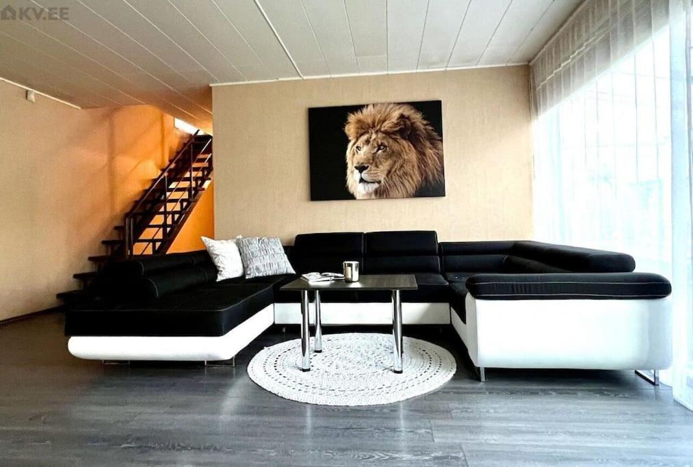 a living room with a lion painting on the wall at Villa in Tallinn