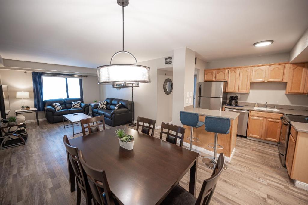 a kitchen and living room with a table and a dining room at Stay Together Suites on The Strip - 2 Bedroom Condo 926 in Las Vegas